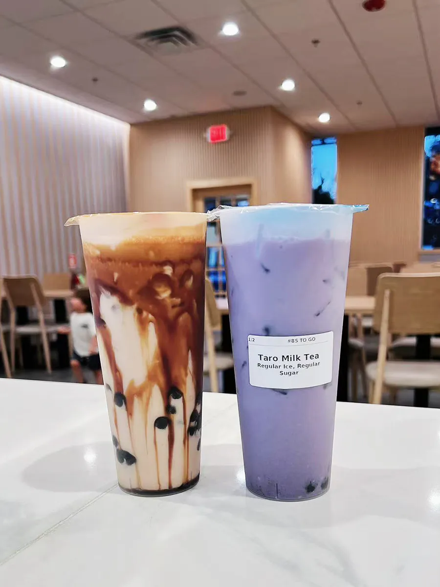 Dual bubble milk tea cups with taro and brown sugar flavors at Mochi & Crunch Treats, a Modern Dessert Café in Tupelo